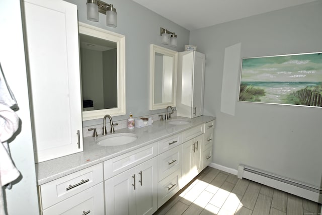 33 Oneil Rd, Oxford, CT 06478 - bathroom featuring a baseboard radiator, double vanity, and wood finished floors