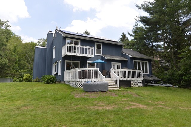 33 Oneil Rd, Oxford, CT 06478 - rear view of property with a lawn, a chimney, a balcony, and roof mounted solar panels
