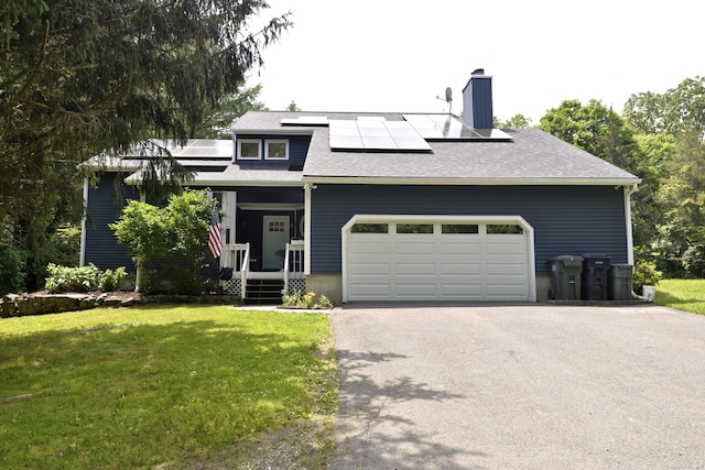 33 Oneil Rd, Oxford, CT 06478 - view of front facade with driveway, a front yard, a chimney, solar panels, and a garage