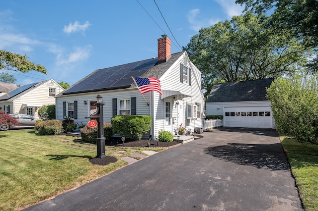 33 Thorpe St, North Haven, CT 06473 - view of front facade featuring a chimney, a front yard, roof mounted solar panels, a garage, and roof with shingles