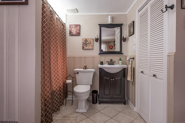 33 Thorpe St, North Haven, CT 06473 - full bath featuring tile patterned floors, vanity, a closet, a wainscoted wall, and crown molding