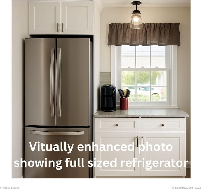 33 Thorpe St, North Haven, CT 06473 - kitchen with freestanding refrigerator, light countertops, and white cabinets