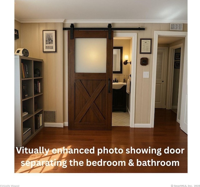 33 Thorpe St, North Haven, CT 06473 - hall featuring crown molding, a barn door, and wood finished floors
