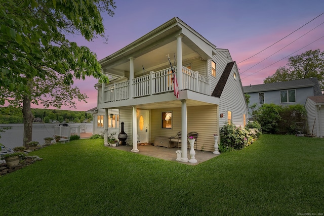 11 Bayside Dr, Wales, MA 01081 - back of house at dusk with a balcony and a patio area