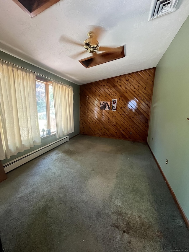 260 Capitol Ave, Waterbury, CT 06705 - unfurnished living room with a baseboard heating unit, wood walls, and carpet