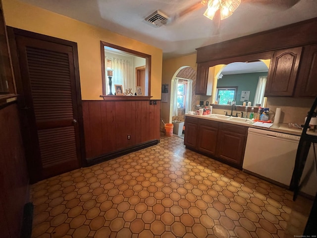 260 Capitol Ave, Waterbury, CT 06705 - kitchen featuring white dishwasher, a wainscoted wall, arched walkways, light countertops, and a ceiling fan