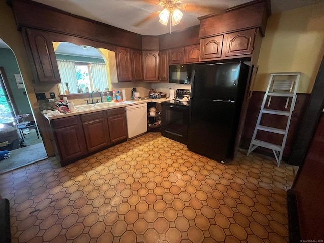 260 Capitol Ave, Waterbury, CT 06705 - kitchen with black appliances, arched walkways, light countertops, and a ceiling fan