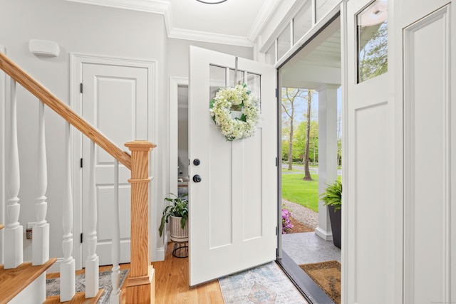 261 W St, Hebron, CT 06248 - entrance foyer with ornamental molding, stairs, and light wood-style flooring
