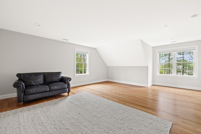 261 W St, Hebron, CT 06248 - living area with wood finished floors, vaulted ceiling, and recessed lighting