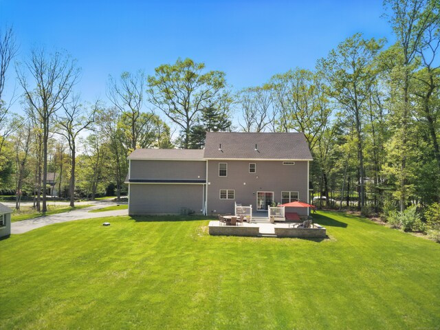261 W St, Hebron, CT 06248 - rear view of house featuring a yard, a patio area, and a deck