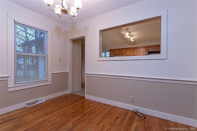 37 Landin St, Woodbridge, CT 06525 - empty room with a chandelier and wood finished floors