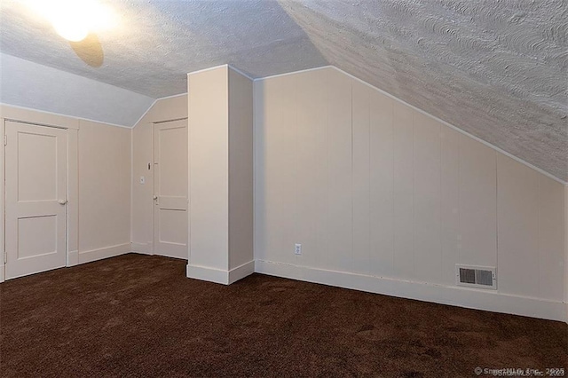 37 Landin St, Woodbridge, CT 06525 - additional living space featuring dark carpet, vaulted ceiling, and a textured ceiling