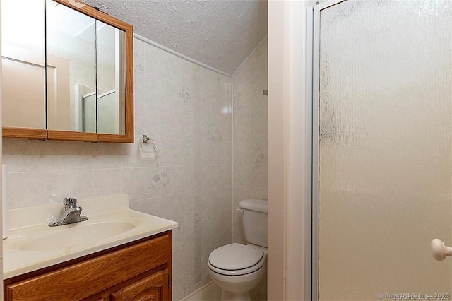 37 Landin St, Woodbridge, CT 06525 - bathroom featuring vanity, a shower stall, tile walls, and a textured ceiling