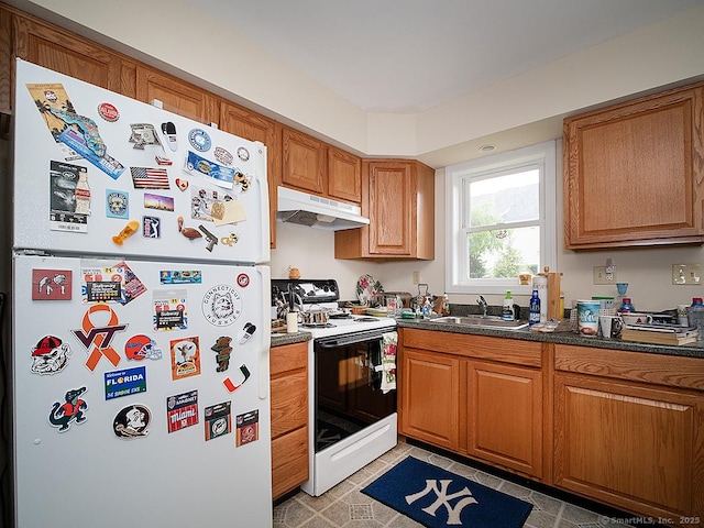 37 Landin St, Woodbridge, CT 06525 - kitchen featuring freestanding refrigerator, under cabinet range hood, range with electric stovetop, brown cabinets, and dark countertops