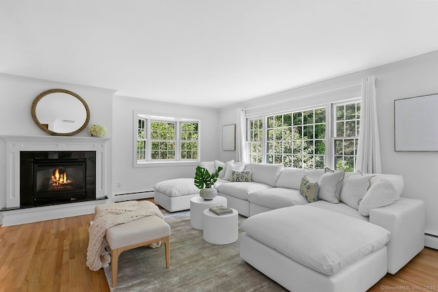 20 Aspen Mill Rd, Ridgefield, CT 06877 - living area with a baseboard heating unit, wood finished floors, and a glass covered fireplace
