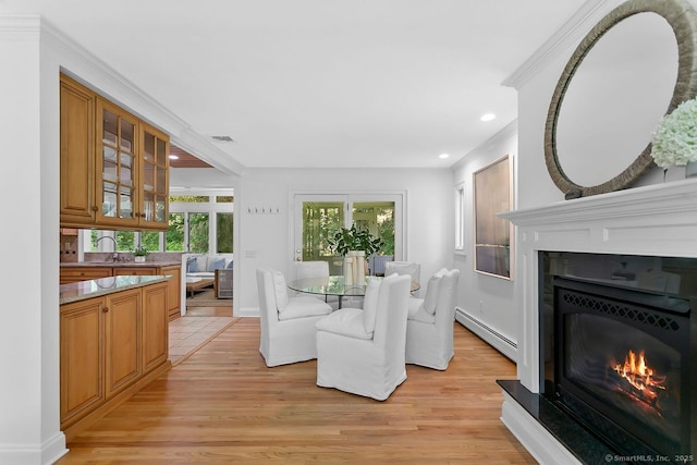 20 Aspen Mill Rd, Ridgefield, CT 06877 - dining area with baseboard heating, light wood-type flooring, a warm lit fireplace, recessed lighting, and crown molding