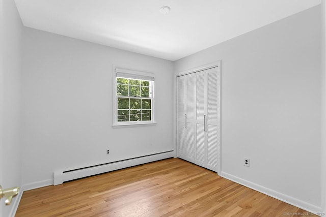 20 Aspen Mill Rd, Ridgefield, CT 06877 - unfurnished bedroom with baseboard heating, light wood-style floors, and a closet