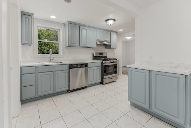 37 Quarry Rd, Beacon Falls, CT 06403 - kitchen with appliances with stainless steel finishes, gray cabinetry, under cabinet range hood, light countertops, and light tile patterned flooring