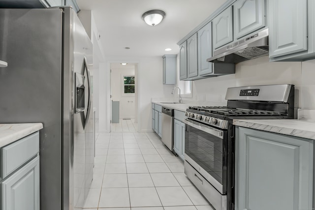 37 Quarry Rd, Beacon Falls, CT 06403 - kitchen with stainless steel appliances, under cabinet range hood, light tile patterned floors, light stone countertops, and recessed lighting