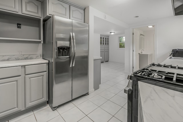 37 Quarry Rd, Beacon Falls, CT 06403 - kitchen featuring stainless steel fridge with ice dispenser, gas range, light tile patterned floors, and gray cabinetry