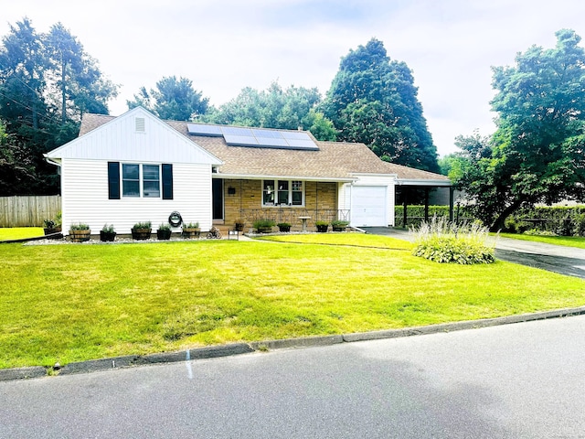 78 French St, Bristol, CT 06010 - view of front facade featuring asphalt driveway, a garage, roof mounted solar panels, and a carport