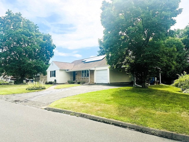 78 French St, Bristol, CT 06010 - ranch-style home featuring asphalt driveway, an attached garage, roof mounted solar panels, and a front yard
