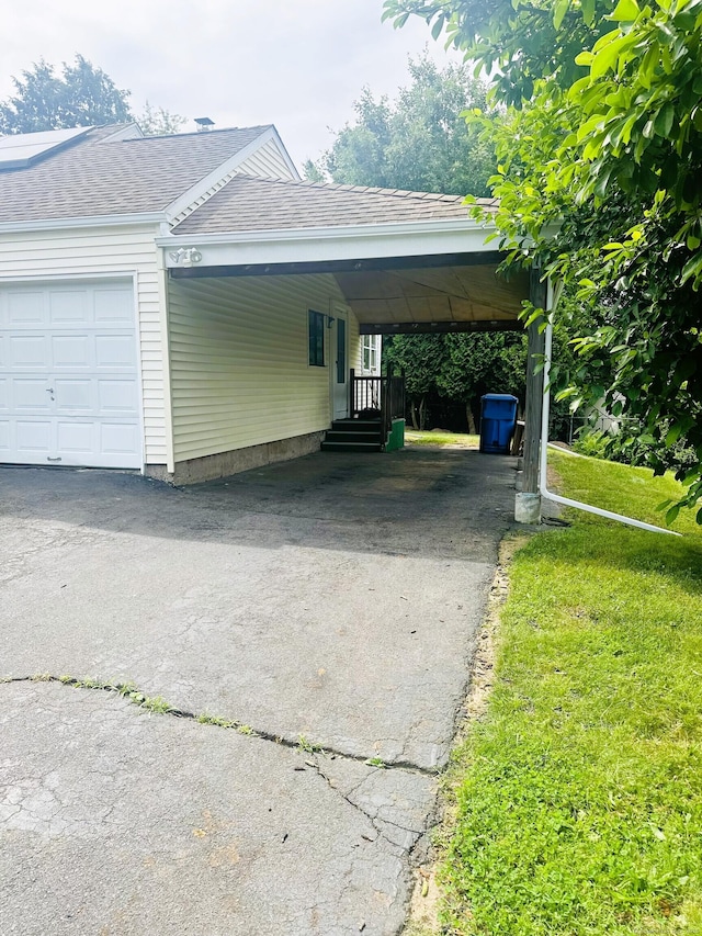 78 French St, Bristol, CT 06010 - view of side of home featuring asphalt driveway, a shingled roof, an attached carport, and a lawn