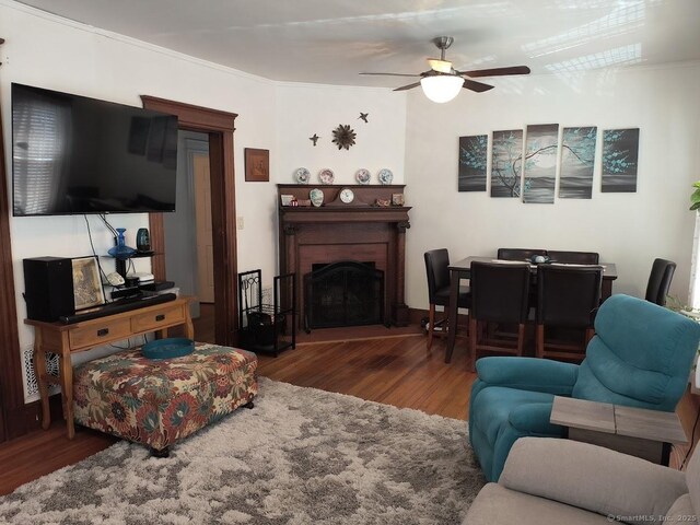463 Washington Ave, West Haven, CT 06516 - living room featuring wood finished floors, ornamental molding, ceiling fan, and a fireplace with raised hearth