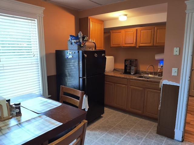 463 Washington Ave, West Haven, CT 06516 - kitchen with freestanding refrigerator, brown cabinets, and dark countertops