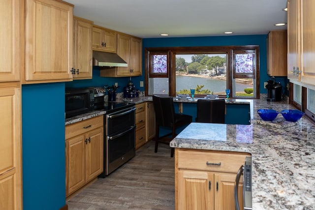 105 Beckett Ave Unit 105, Branford, CT 06405 - kitchen featuring under cabinet range hood, range with two ovens, black microwave, wood finished floors, and a water view