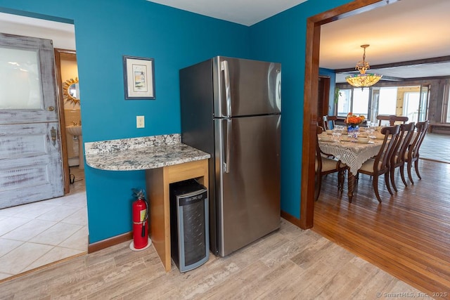105 Beckett Ave Unit 105, Branford, CT 06405 - kitchen featuring freestanding refrigerator, light wood-type flooring, and light stone countertops