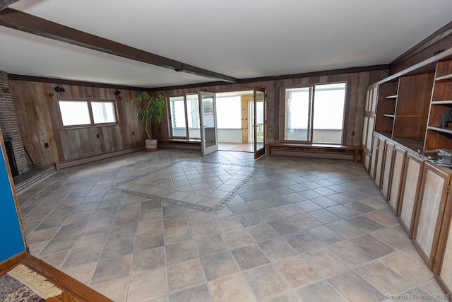 105 Beckett Ave Unit 105, Branford, CT 06405 - unfurnished living room featuring wood walls, a baseboard radiator, and beam ceiling
