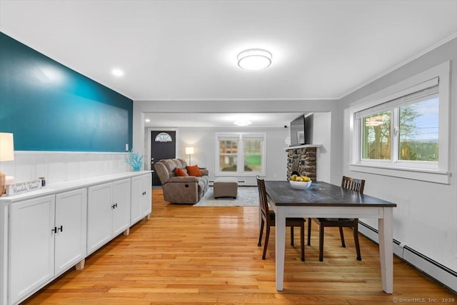 10 3rd Ave, Haddam, CT 06441 - dining area featuring ornamental molding, light wood-type flooring, a baseboard heating unit, and a wainscoted wall