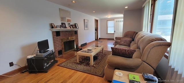 4 Clyne Ave, Waterbury, CT 06705 - living room featuring healthy amount of natural light, light wood-style floors, a fireplace, and recessed lighting