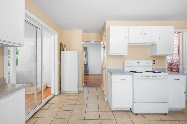 350 S Cherry St, Wallingford, CT 06492 - kitchen featuring white electric stove, white cabinetry, light countertops, and light tile patterned floors
