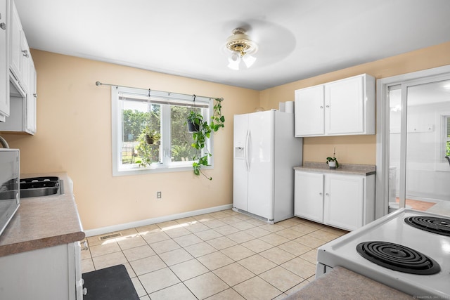350 S Cherry St, Wallingford, CT 06492 - kitchen featuring white appliances, white cabinets, a ceiling fan, and light tile patterned flooring