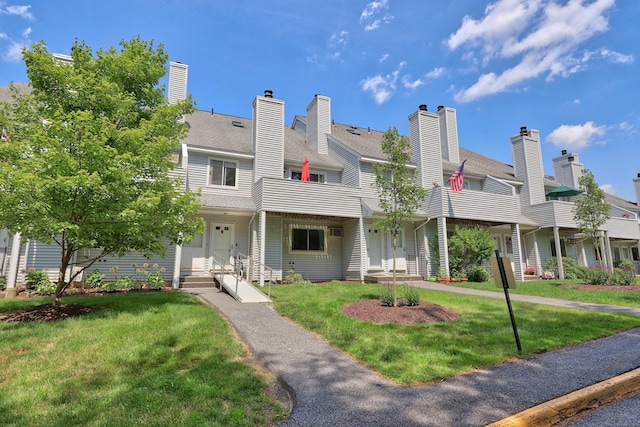 187 Lovers Ln Unit 4, Torrington, CT 06790 - rear view of house featuring a yard, a chimney, and a residential view