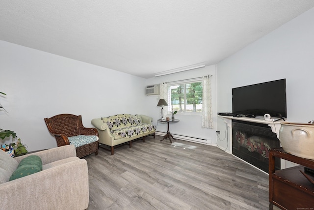 187 Lovers Ln Unit 4, Torrington, CT 06790 - living area with a baseboard radiator, wood finished floors, and a wall unit AC