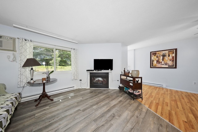 187 Lovers Ln Unit 4, Torrington, CT 06790 - living room with wood finished floors, a baseboard heating unit, and a fireplace