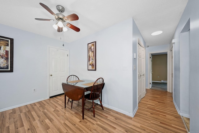 187 Lovers Ln Unit 4, Torrington, CT 06790 - dining space with light wood-type flooring, ceiling fan, and baseboard heating