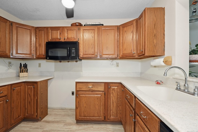 187 Lovers Ln Unit 4, Torrington, CT 06790 - kitchen with black microwave, brown cabinets, and light countertops
