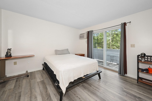 187 Lovers Ln Unit 4, Torrington, CT 06790 - bedroom with access to exterior, wood finished floors, and a wall unit AC