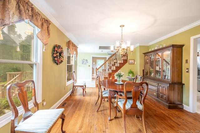 79 Ben Whitney Ln, Bridgewater, CT 06752 - dining room with a chandelier, stairs, plenty of natural light, light wood-type flooring, and crown molding