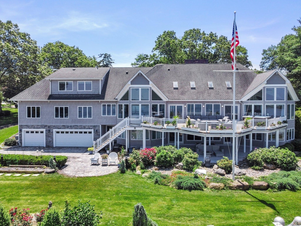 12 Rocky Point Rd, Old Saybrook, CT 06475 - rear view of house featuring a garage, a patio area, a deck, a lawn, and driveway