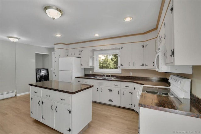 57 Lakeview Hts, Lebanon, CT 06249 - kitchen with white appliances, washer / dryer, dark countertops, white cabinets, and a kitchen island