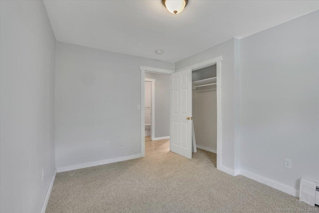 57 Lakeview Hts, Lebanon, CT 06249 - unfurnished bedroom with light colored carpet, a closet, and a baseboard heating unit