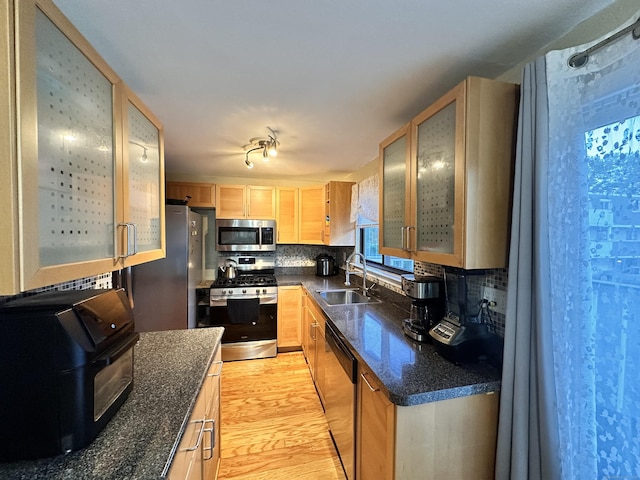 74 Churchill Dr Unit 74, Newington, CT 06111 - kitchen featuring stainless steel appliances, light wood finished floors, light brown cabinetry, glass insert cabinets, and backsplash