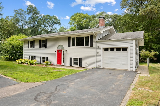 41 Laurel Leaf Dr, Ledyard, CT 06335 - split foyer home with a garage, a chimney, a front lawn, and asphalt driveway