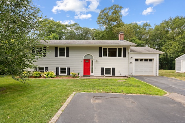 41 Laurel Leaf Dr, Ledyard, CT 06335 - split foyer home featuring a garage, driveway, a chimney, and a front yard