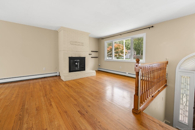 41 Laurel Leaf Dr, Ledyard, CT 06335 - living room featuring wood finished floors, a fireplace, and baseboard heating